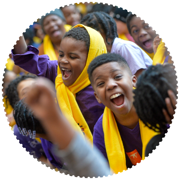 Two students wearing School Choice Week scarves cheer at an event
