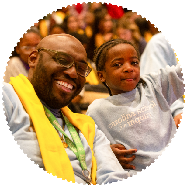 A father and his son smile for the camera