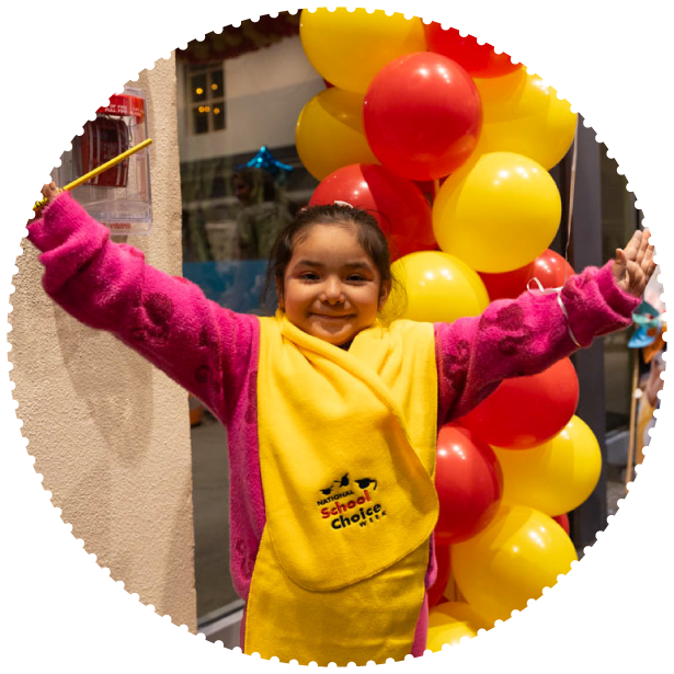 A girl wearing a School Choice Week scarf poses for a photo
