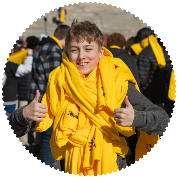 A student wears a massive collection of scarves around his neck at a capitol rally