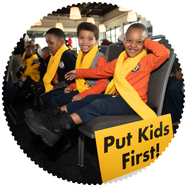 Two students wearing scarves smile for the photo