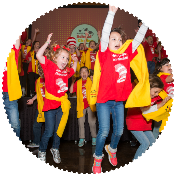 A group of students jump and cheer at an event