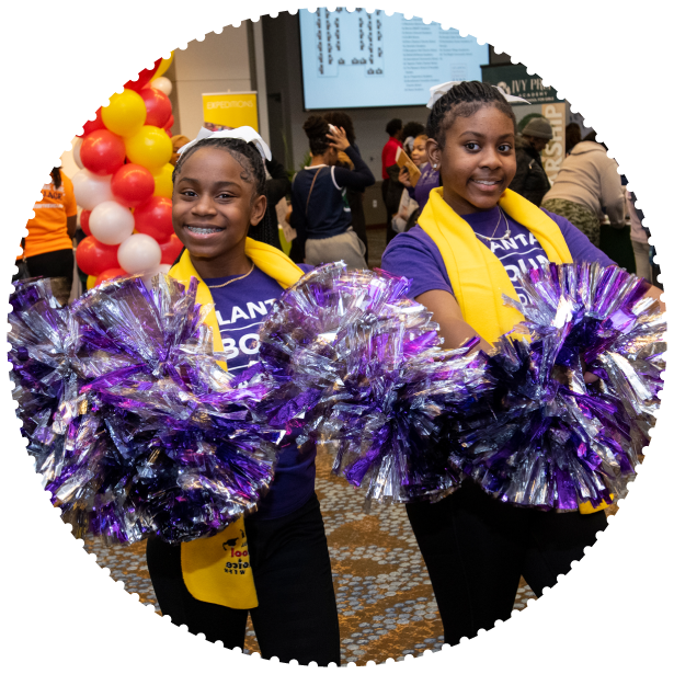 To students holding pom poms and School Choice Week scarves pose for a photo